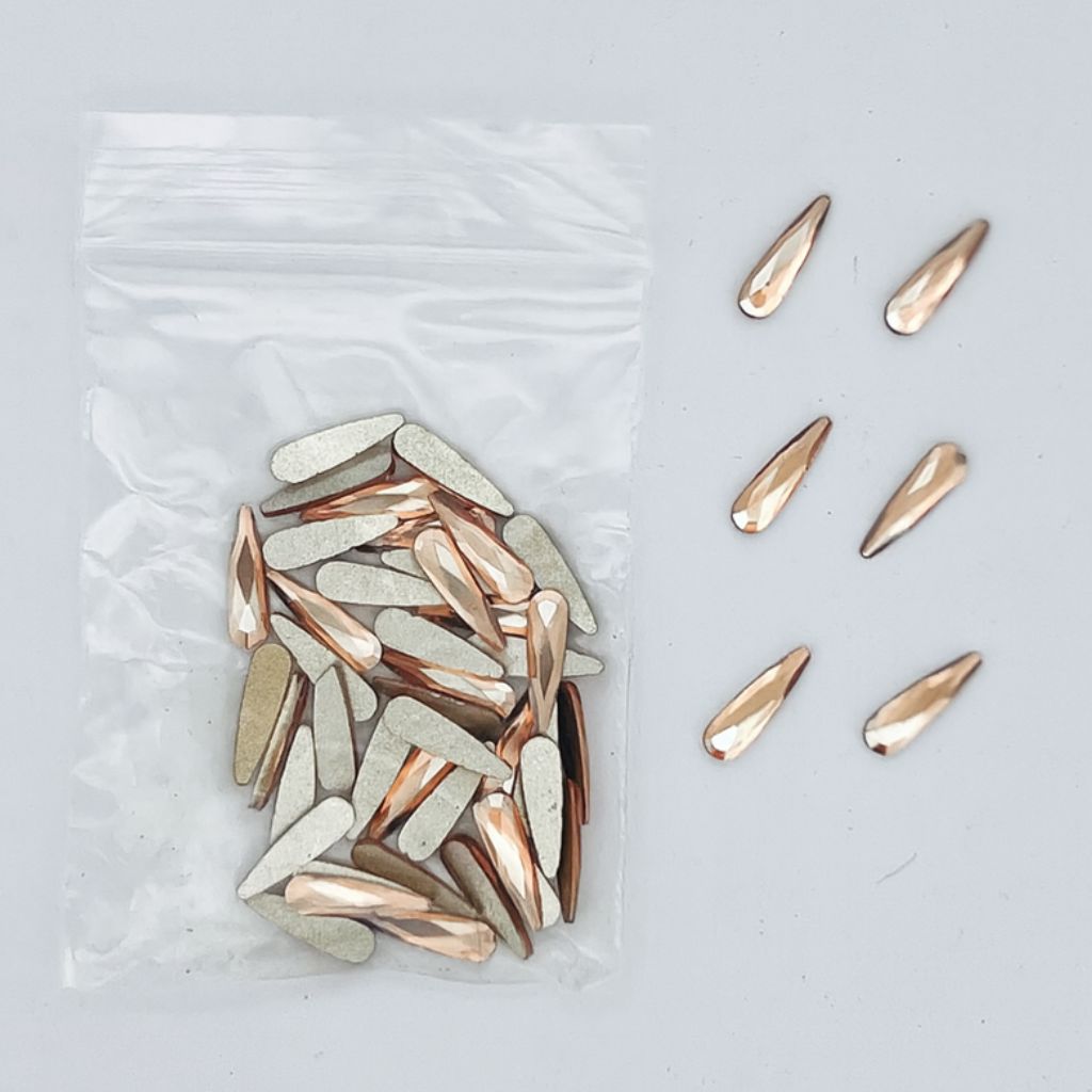 Gold teardrop nail art rhinestones — faceted flatbacks in zip bag with loose samples (NSI Australia)