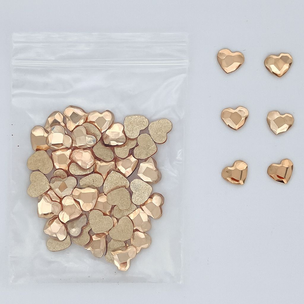 Gold heart-shaped nail art rhinestones — faceted flatbacks in zip bag with loose samples (NSI Australia)