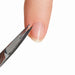 Nail Success Australia stainless steel nail and cuticle scissors trimming cuticles beside a natural fingernail for precise manicure grooming