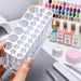 Clear Acrylic Nail Art Brush and Tool Holder with multi-size slots displayed with nail polish, files and salon accessories