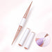 White and rose gold double-ended nail art liner brush with two protective caps, shown painting a white curved line on a purple nail.
