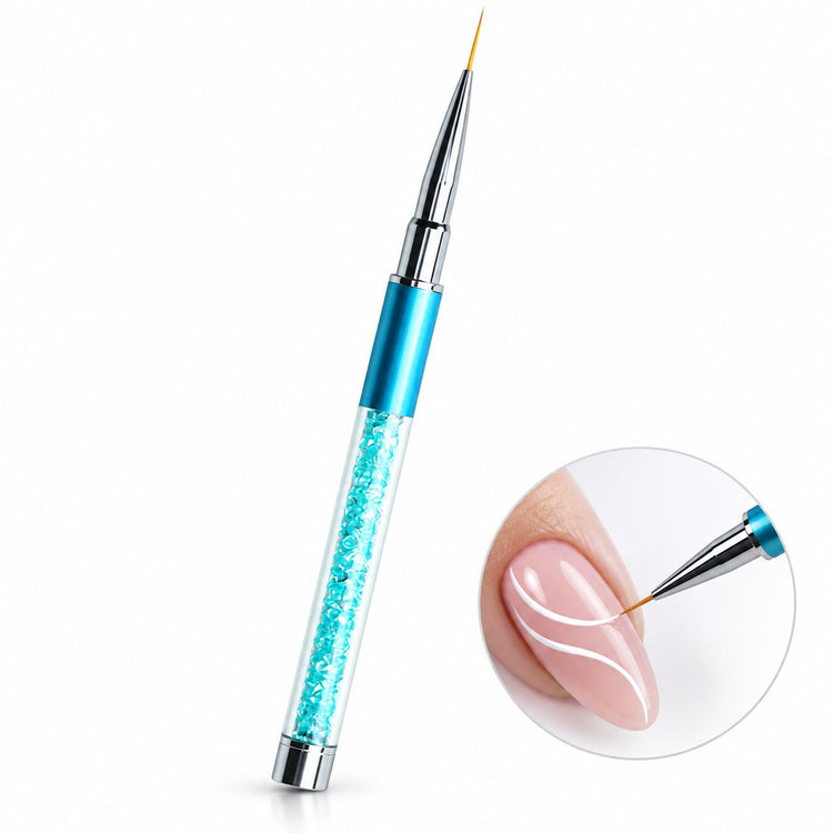 Sky blue 9 mm nail art liner brush with crystal-filled handle, shown painting curved white lines on a nude pink nail.