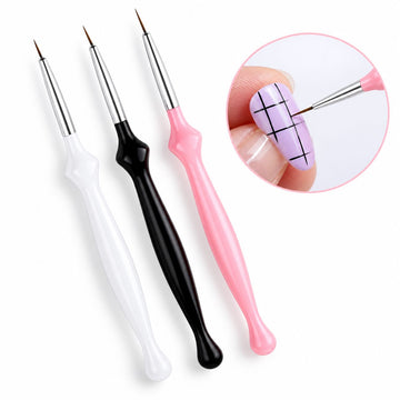 Set of three nail art liner brushes with white, black and pink handles, shown painting fine black grid lines on a lilac nail.