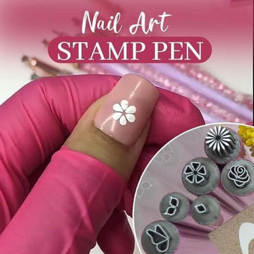 Nail art stamp pen with metal pattern tips, pressing a white flower design onto a pink nail