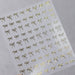 Gold bow nail art stickers sheet with delicate metallic ribbon designs for elegant salon manicure decorations