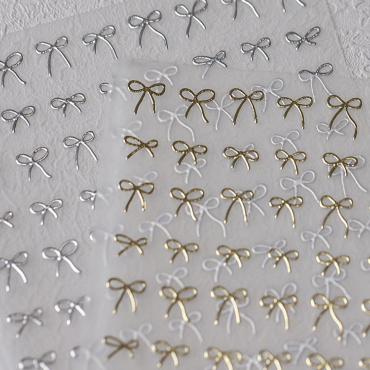 Gold and silver bow nail art stickers pack with delicate metallic ribbon designs for elegant salon manicure decorations