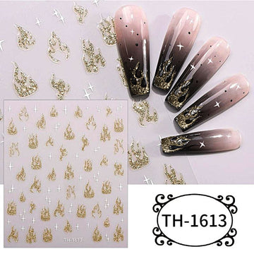 Glitter gold flame nail art stickers with white stars, shown on a sheet and applied to pink and black ombré coffin nails.
