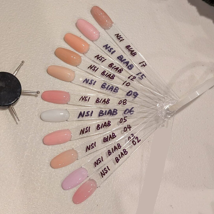 Nail Success HEMA-Free BIAB builder gel swatch fan—shades 02–06, 08–10, 12, 15, 17 (pinks, nudes, milky white, glitter)