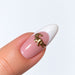 Gold plated crocodile nail charm on a pink and white French almond nail, NSI Australia