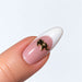 Gold plated elephant nail charm on a pink and white French almond nail, NSI Australia