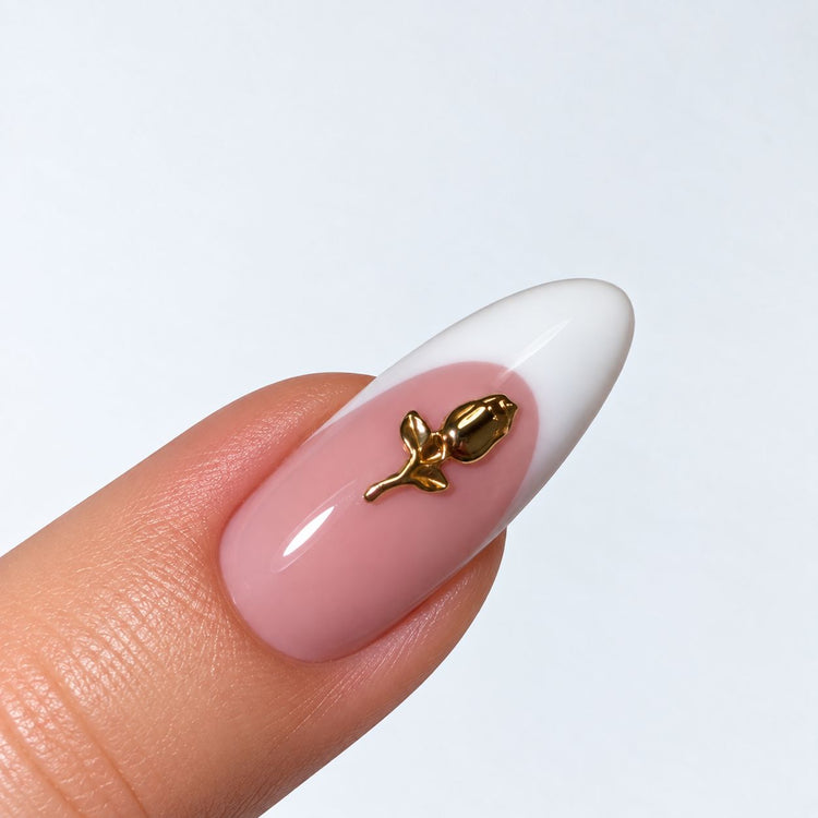 Gold plated rose bud nail charm on a pink and white French almond nail, NSI Australia