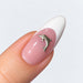Silver tone small dolphin nail charm on a pink and white French almond nail, NSI Australia