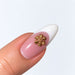 Gold plated snowflake nail charm on a pink and white French almond nail, NSI Australia