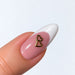 Gold plated twin hearts nail charm on a pink and white French almond nail, NSI Australia