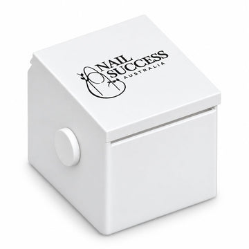 Compact white nail form dispenser with a black Nail Success Australia logo on the sloping lid, a front dispensing slot and round side knob.
