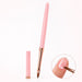 Pink pointed gel nail brush with rose gold ferrule and matching cap, shown applying gel near the cuticle of a natural nail.
