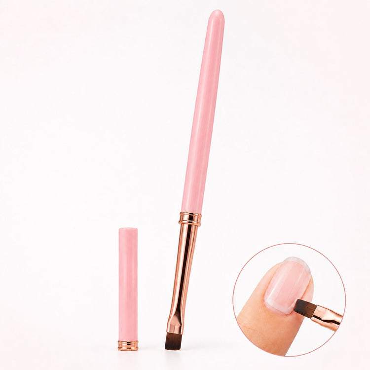 Pink gel nail brush with flat square bristles, rose gold ferrule and matching cap, shown applying gel to a natural nail.
