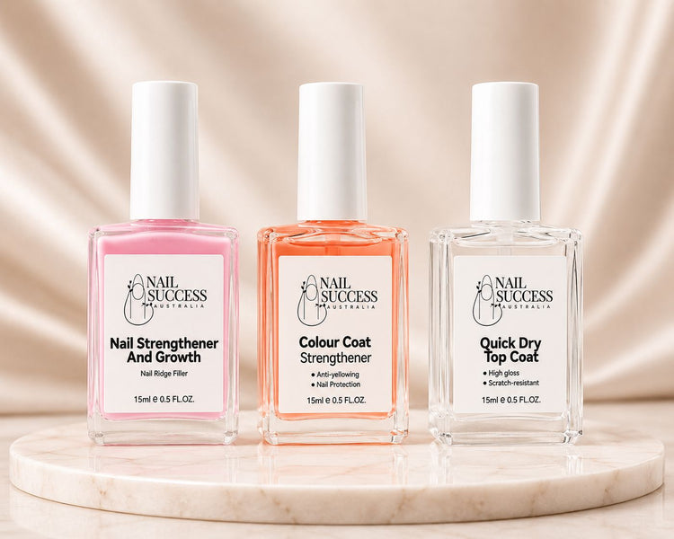 Nail Success Australia 3-step nail strengthening routine with nail strengthener, colour coat strengthener and quick dry top coat on marble display