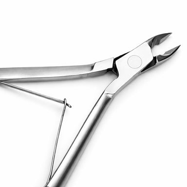 Stainless steel cuticle nipper close-up with sharp precision blades and double spring handle