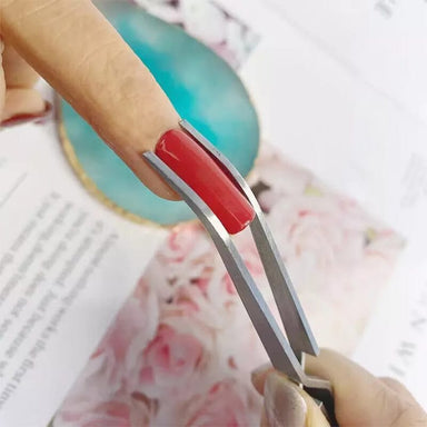 NSI Australia Nail Pinching Tweezers shaping a C-curve on a red acrylic nail
