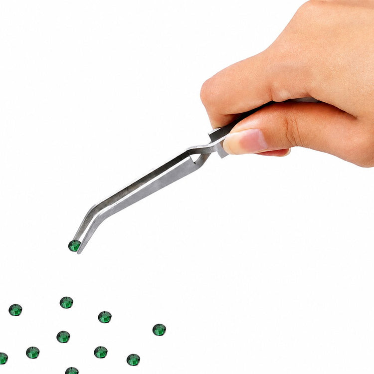 Nail Success Australia stainless steel nail pinching tweezers holding a green rhinestone with angled precision tip for detailed nail art placement