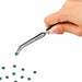 Nail Success Australia stainless steel nail pinching tweezers holding a green rhinestone with angled precision tip for detailed nail art placement
