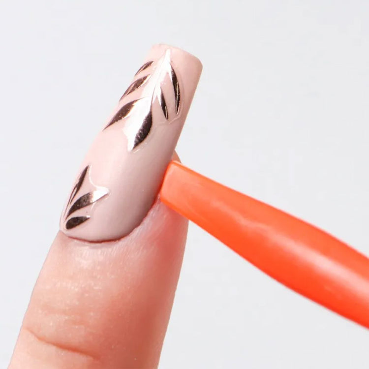 Orange nail suction cup stick holding a decorated false nail tip for easy nail art practice, gel polish application and manicure display work
