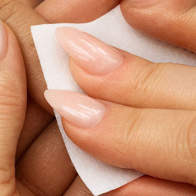 acrylic prep, shown wiping glossy nude nails