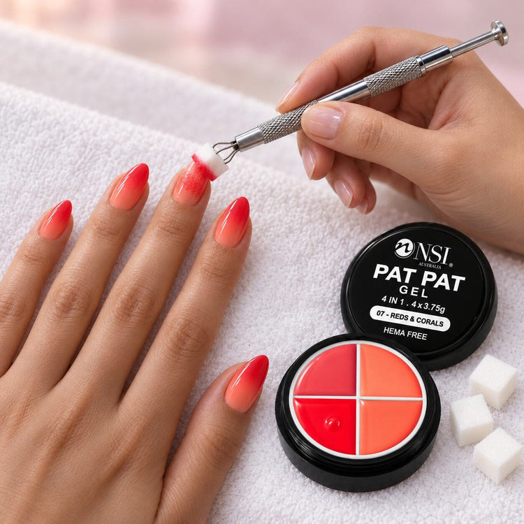 Nail tech patting red and coral ombre onto a client's nails with the 4 Colour - 07 Reds & Corals Pat Pat Gel and a cube sponge in the claw tool