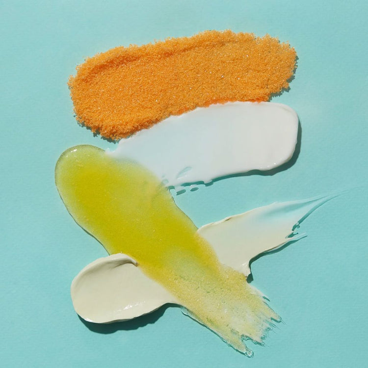 VOESH New York Mango Delight pedicure kit textures with sea salt soak, oil and cream on blue background