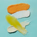 VOESH New York Mango Delight pedicure kit textures with sea salt soak, oil and cream on blue background