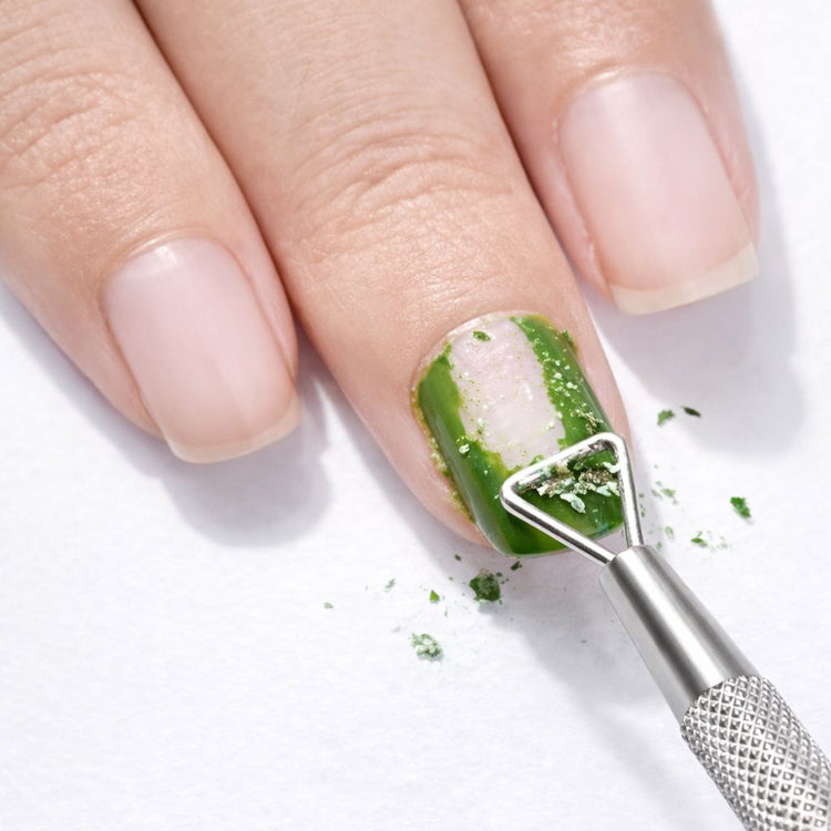 Stainless steel gel polish remover peeler scraper tool removing green gel polish from a natural nail