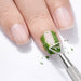 Stainless steel gel polish remover peeler scraper tool removing green gel polish from a natural nail