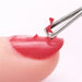 Nail gel polish remover peeler scraper tool removing red gel polish from a fingernail