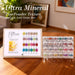 Ultra mineral chrome nail powder set with 24 colors, swatch chart display and stacked pigment jars on wooden table