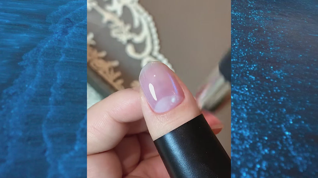 Blue Tears aurora cat eye gel polish texture close-up on brush with sparkling blue shimmer