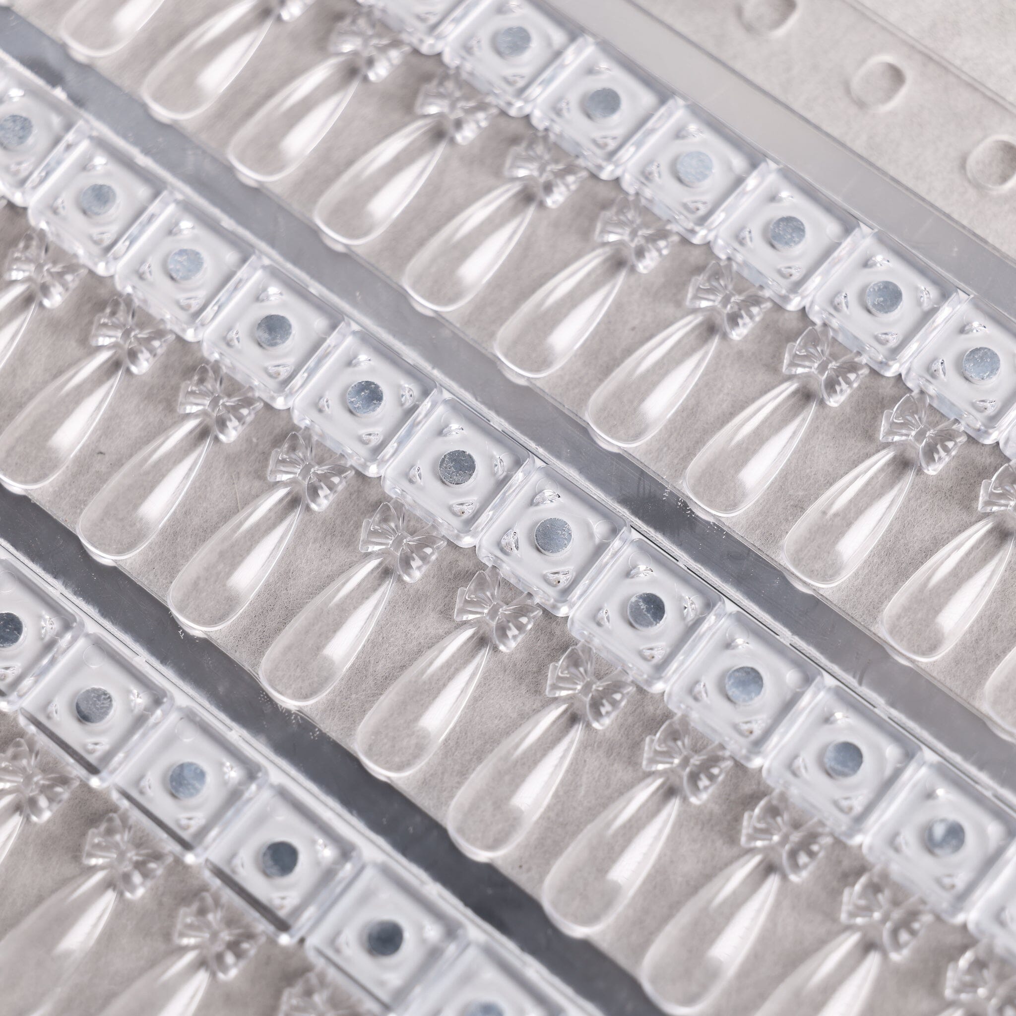 Close-up of NSI Australia Pro Magnetic Swatch Book — rows of clear teardrop gel polish swatch tips on magnetic bases