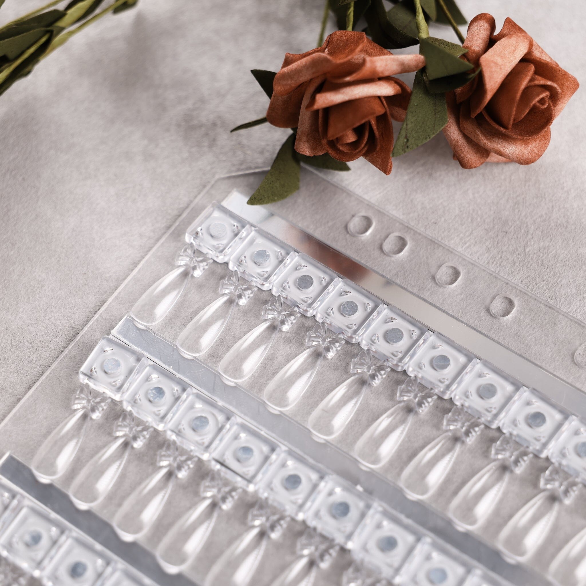 NSI Australia Pro Magnetic Swatch Book refill page — close-up of clear teardrop gel polish swatch tips on magnetic bases with roses