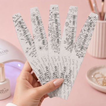 Pro nail file pack with five professional grits 80/80, 100/100, 150/150, 180/180 and 240/240 for acrylic, gel and salon nail shaping held on pink manicure table