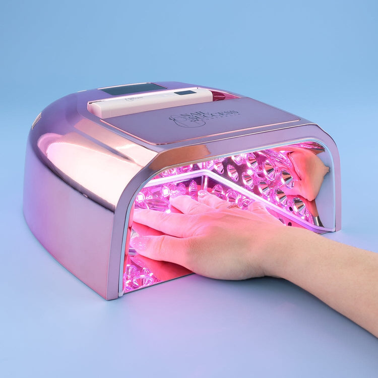 UV nail lamp in rose gold, hand curing gel nails under LED lights