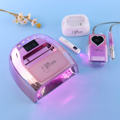 Rose Gold Rechargeable LED UV Nail Lamp and Professional Electric Nail File set with flash torch on blue background
