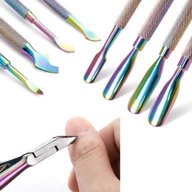 Close-up of rainbow stainless steel nail tools with cuticle nipper trimming a fingernail and assorted manicure tool tips