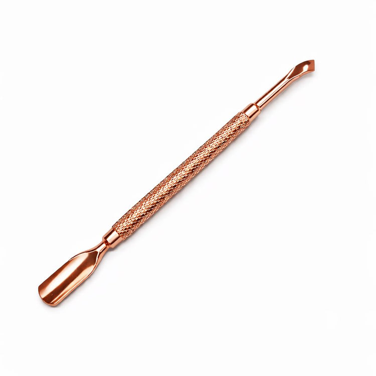 Rose gold double-ended cuticle pusher and angled scraper nail tool with textured grip handle