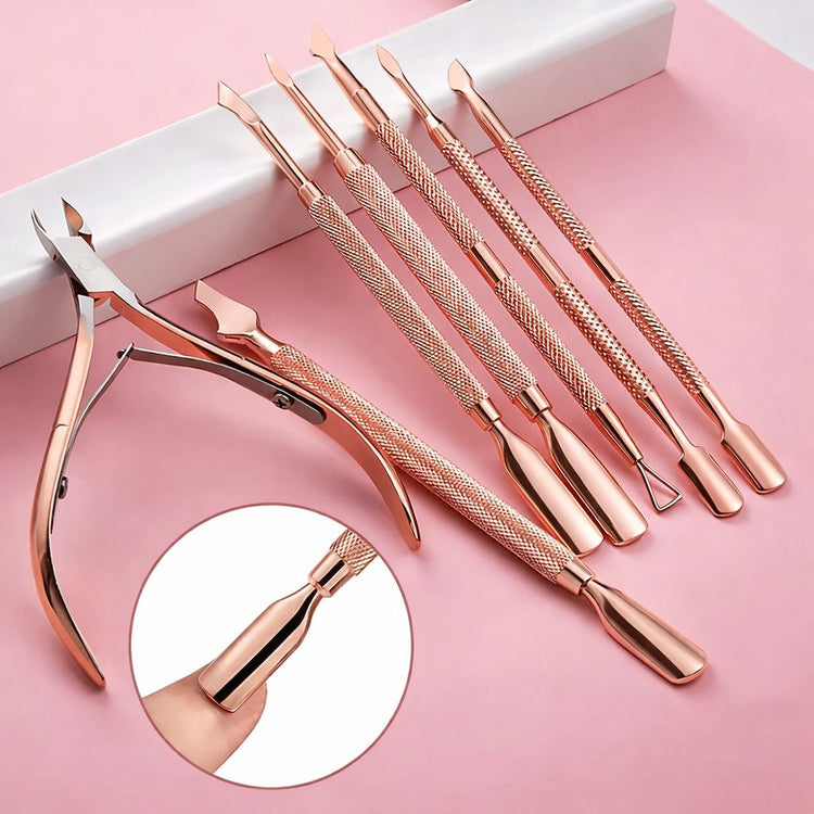 Rose gold nail tool set with cuticle nipper and five stainless steel manicure tools on pink background