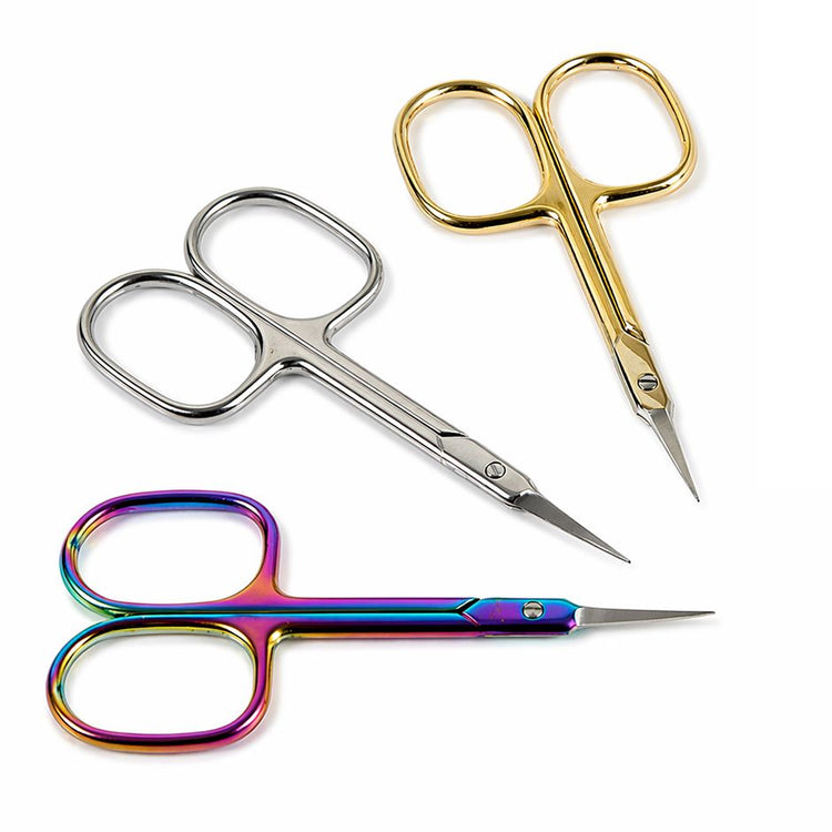 Three precision cuticle scissors in silver, gold and rainbow finishes arranged on a light gray background