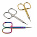 Three precision cuticle scissors in silver, gold and rainbow finishes arranged on a light gray background