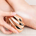 Rose gold shell foot file and callus remover used on heel for washable spa pedicure care