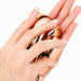 Rose gold shell-shaped foot file and callus remover held in hand for washable spa pedicure care
