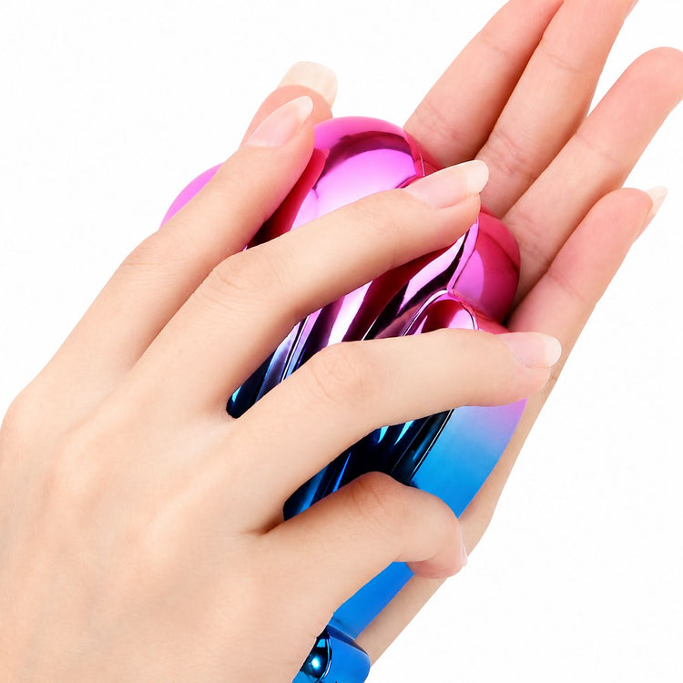Shell-shaped rainbow foot file and callus remover held in hand for washable spa pedicure care