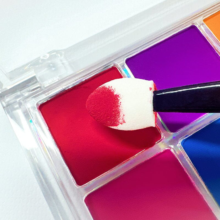 Close-up of red neon gradient nail art powder — sponge applicator dipping into 10-color pigment palette for ombré nails